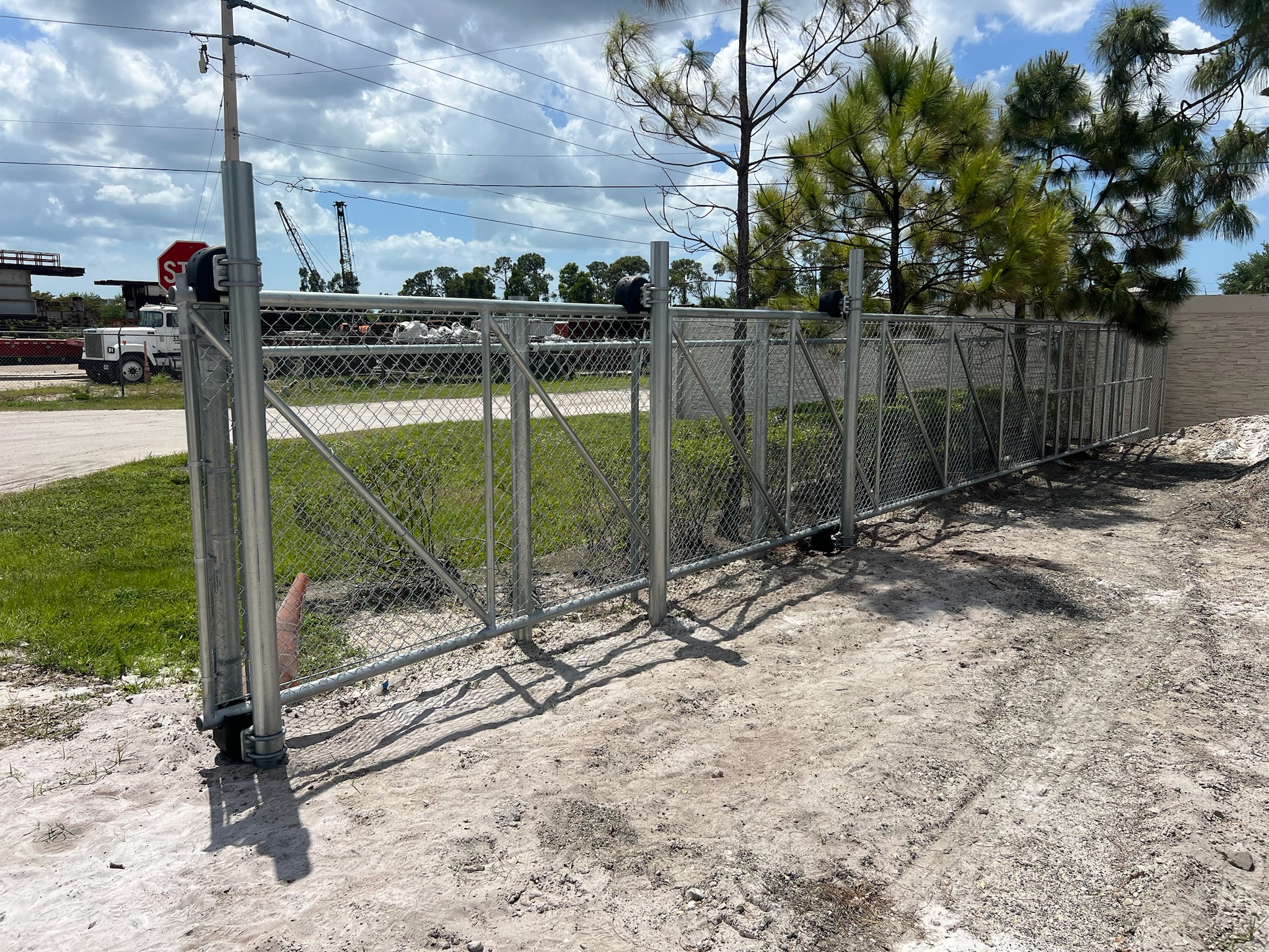 Commercial chain-link rolling gate installed by Southern Hoss Fences